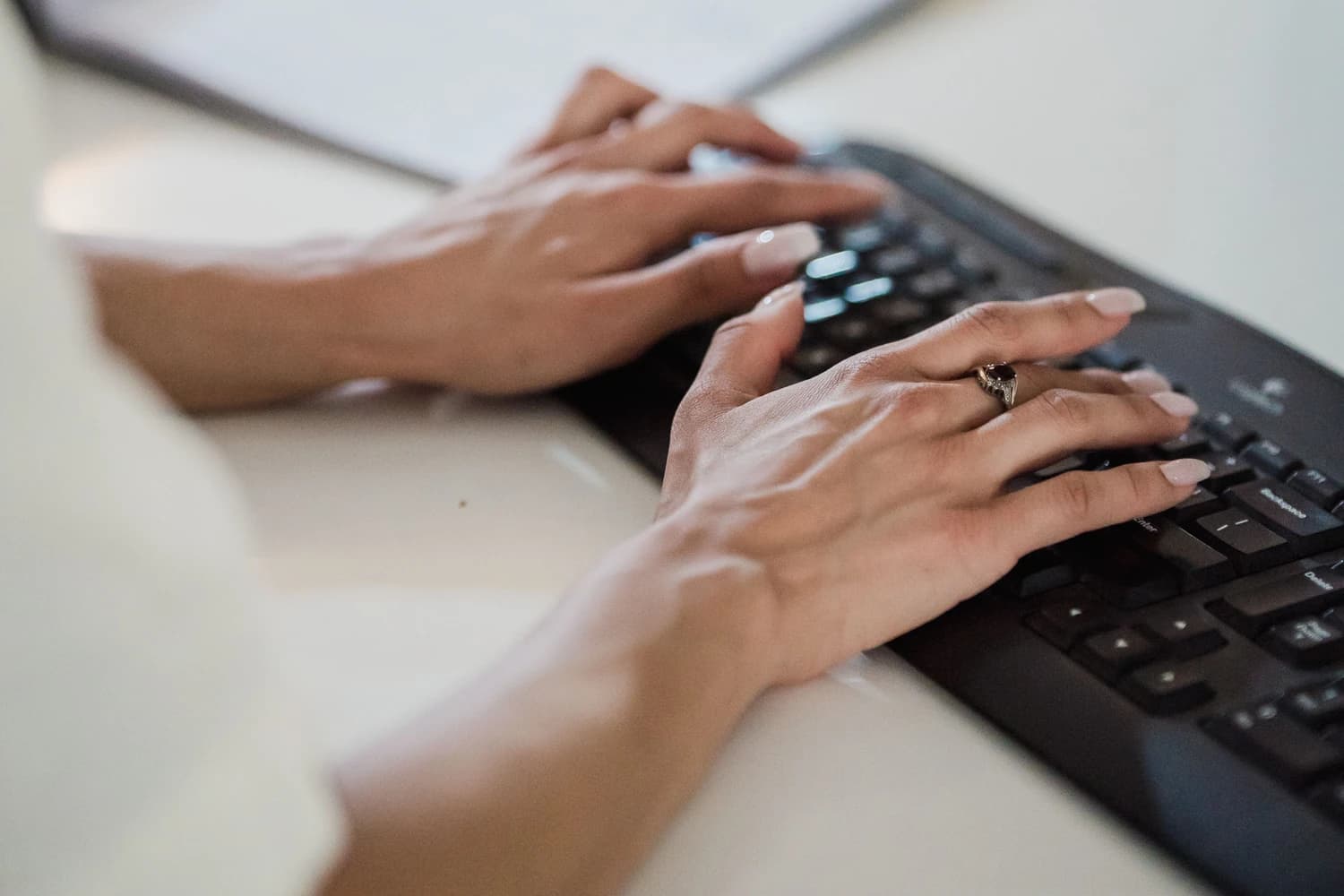 Hands using a keyboard during focused technical work.
