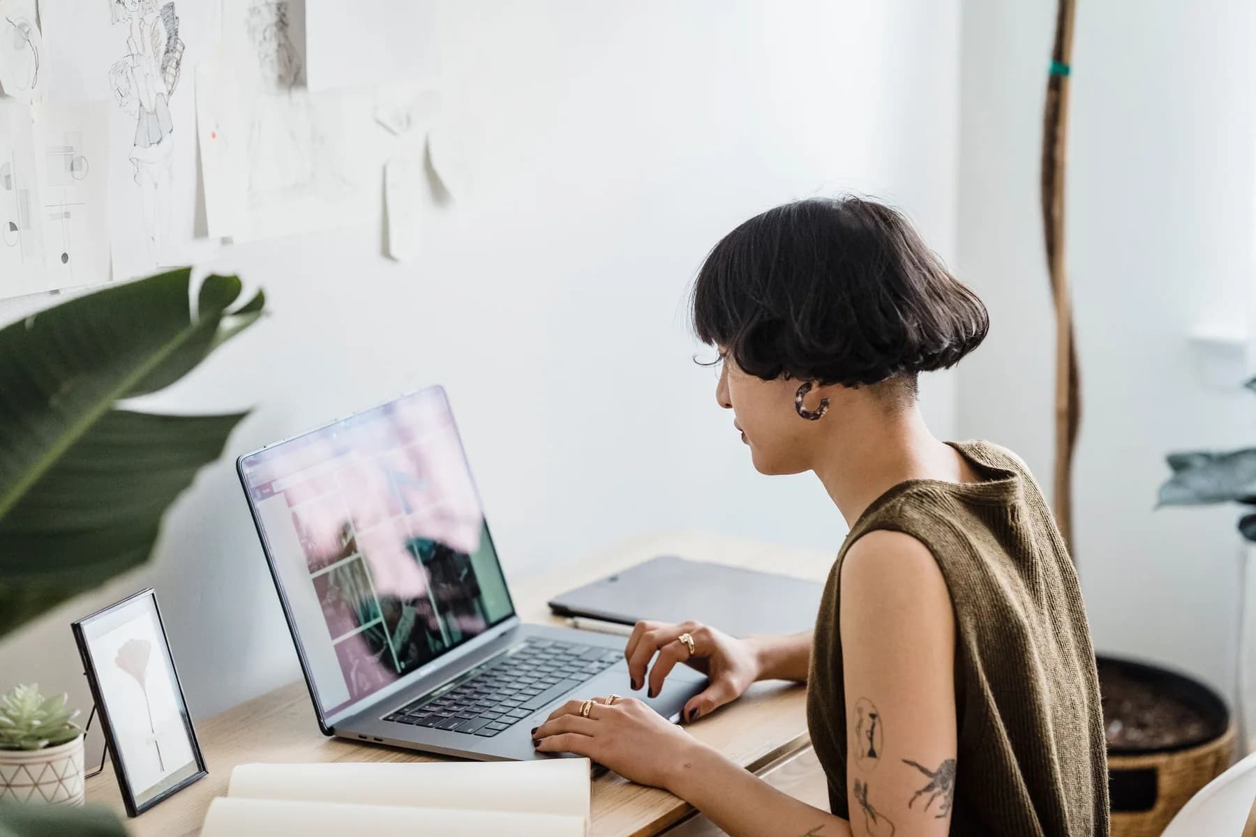 A creative professional developing visual design work at a computer.