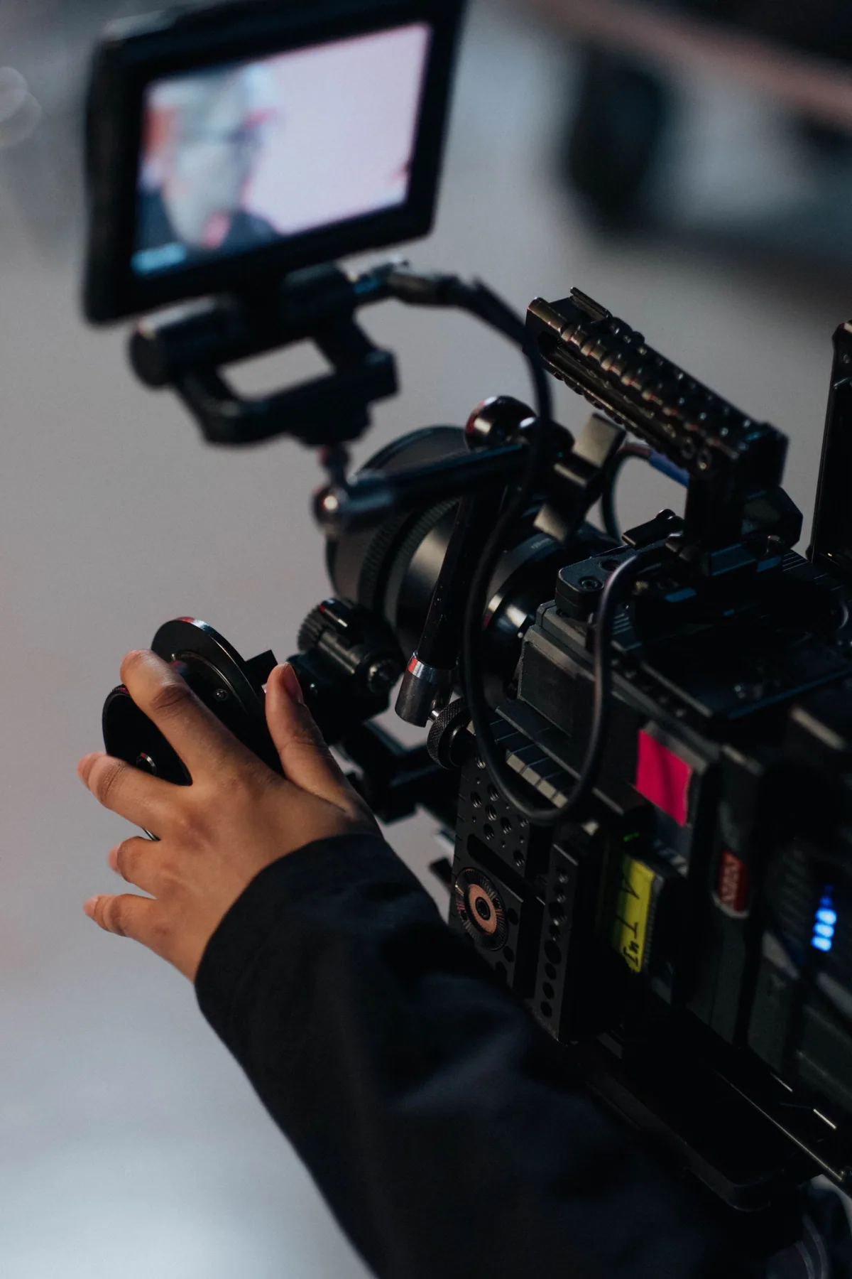 A camera operator preparing a professional production camera.