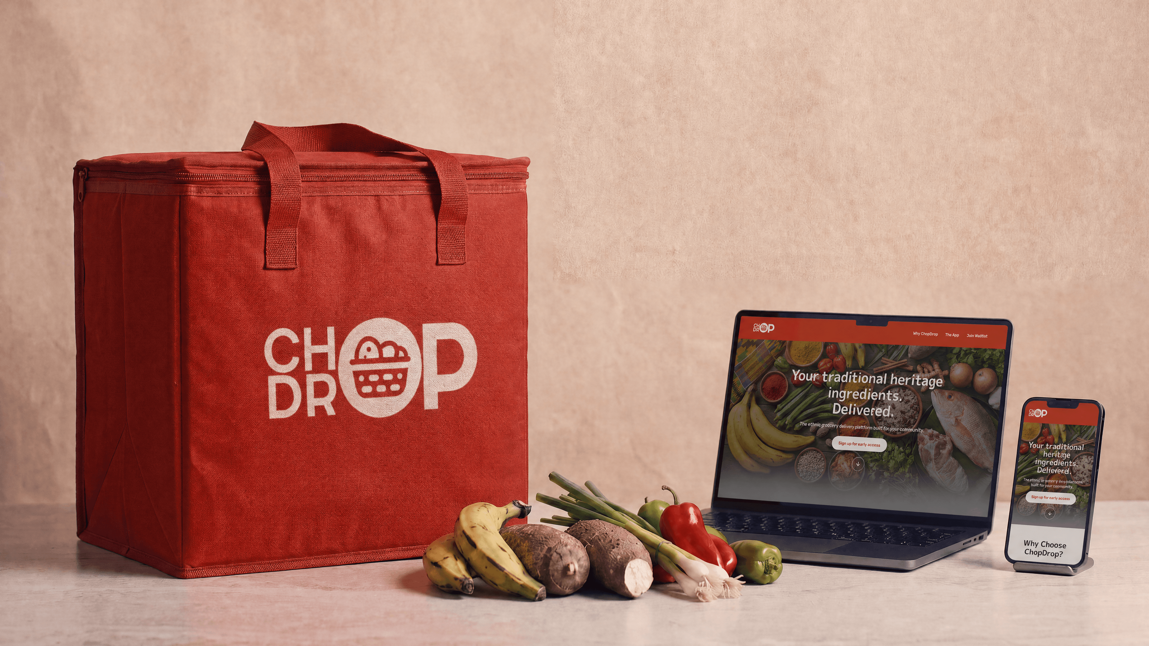 A red ChopDrop delivery bag beside the ChopDrop marketplace shown on a laptop and phone, surrounded by heritage groceries.