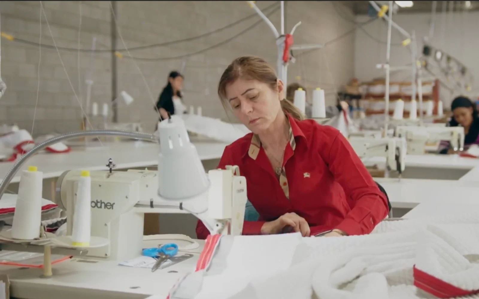 A mattress maker working inside a production facility.