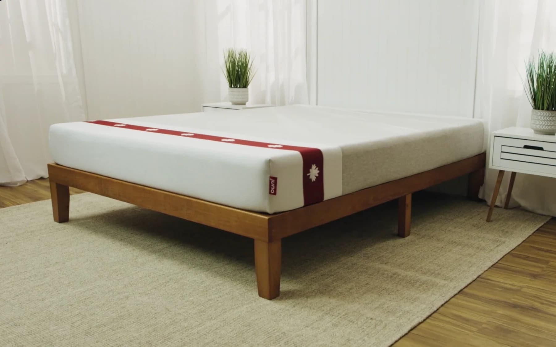 A Juno mattress staged in a bright bedroom.