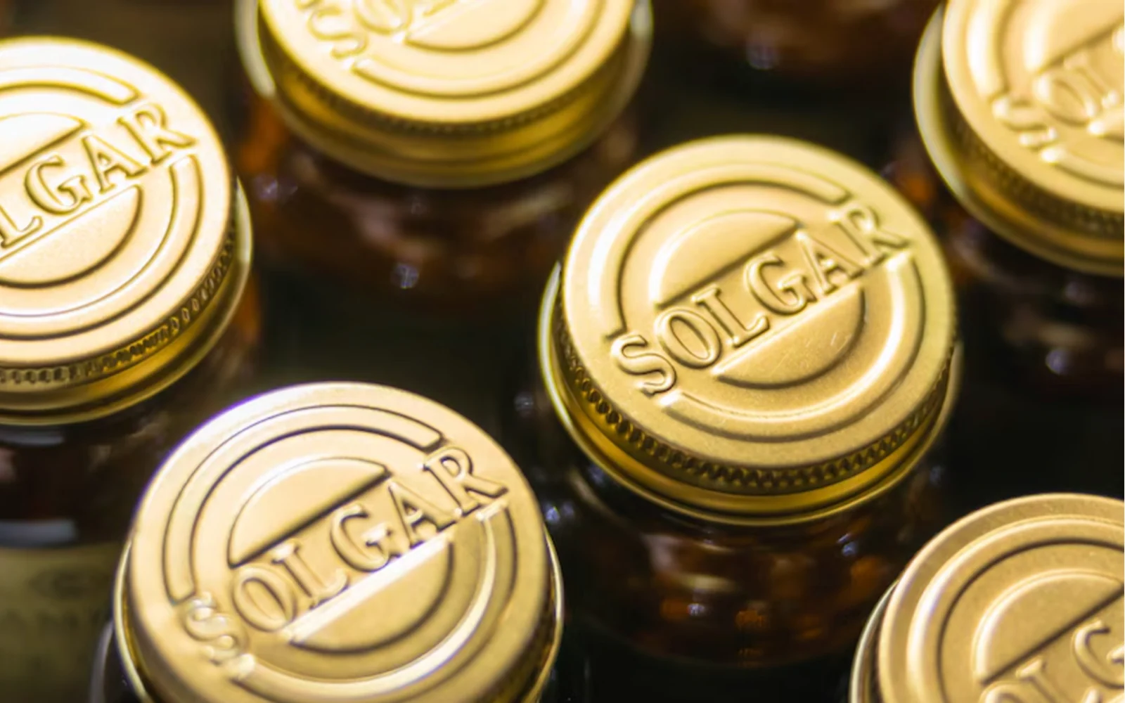 A close-up arrangement of Solgar supplement bottle caps.