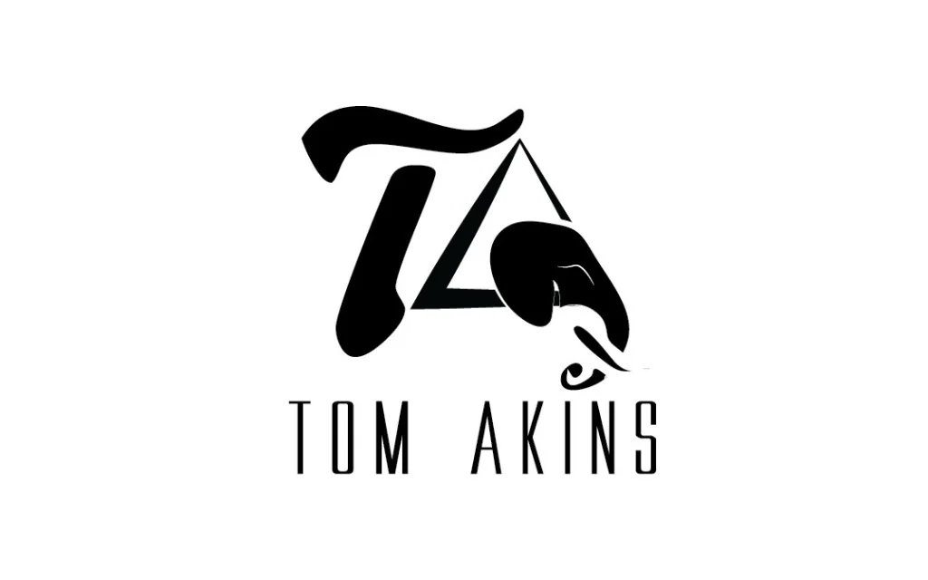The Tom Akins monogram and wordmark in black on white.